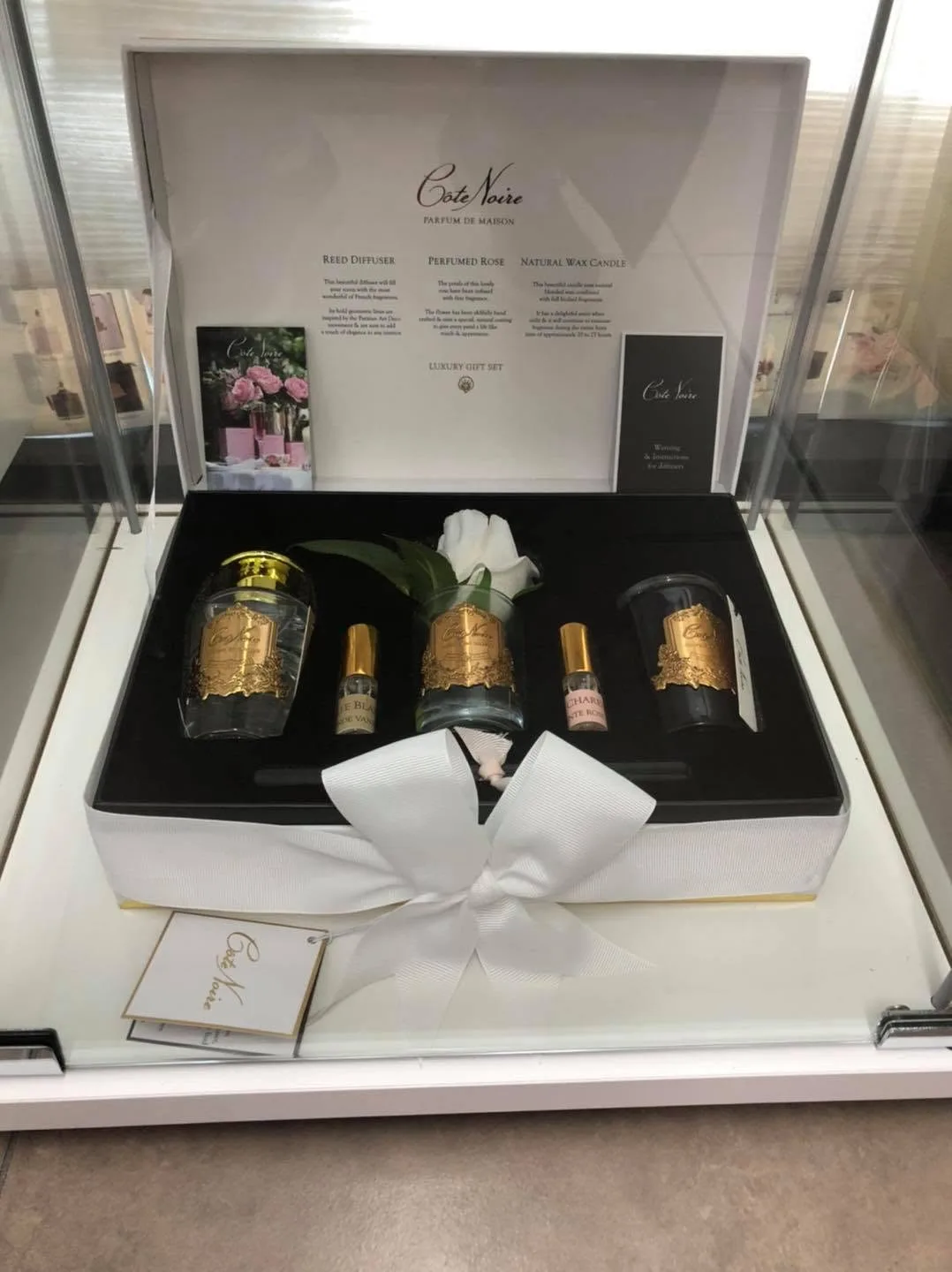 Côte Noire luxury gift set with diffuser, perfumed rose and candle inside a glass display case